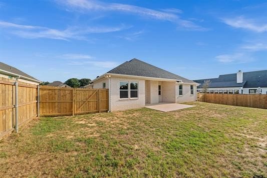 back of property with a patio and a lawn