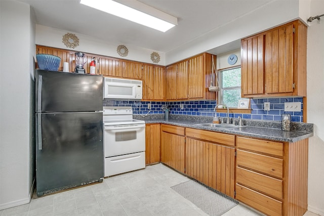 kitchen featuring white appliances, tasteful backsplash, and sink