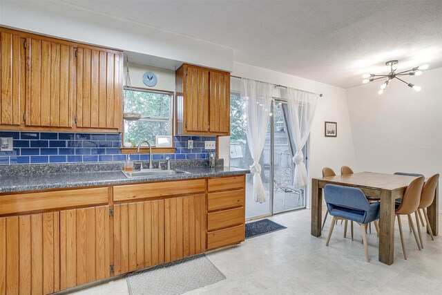 laundry room featuring stacked washing maching and dryer and light tile patterned floors