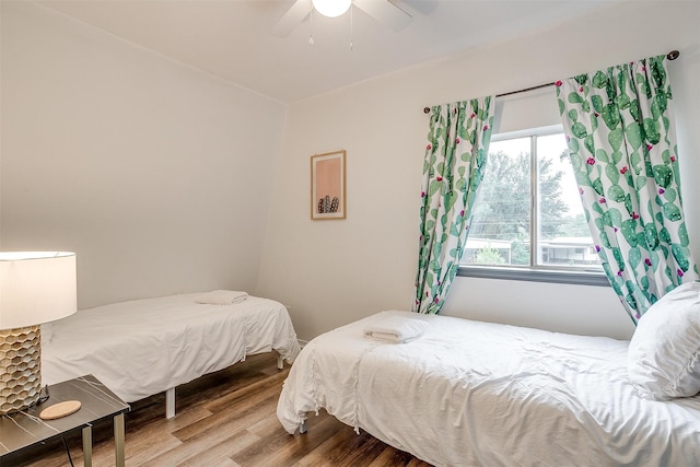 bedroom with ceiling fan and hardwood / wood-style flooring