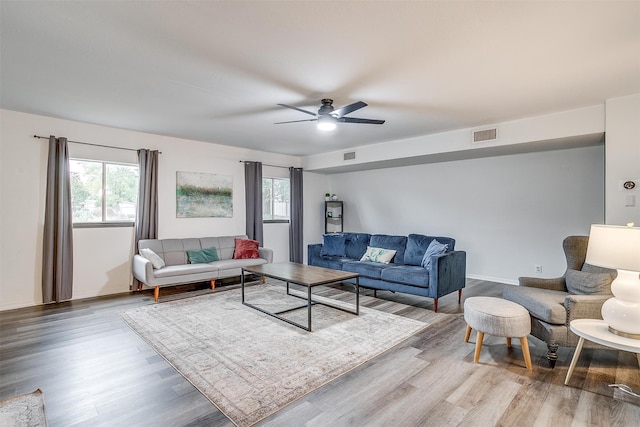 living room featuring wood-type flooring and ceiling fan