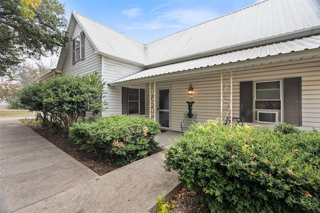 view of exterior entry with a porch