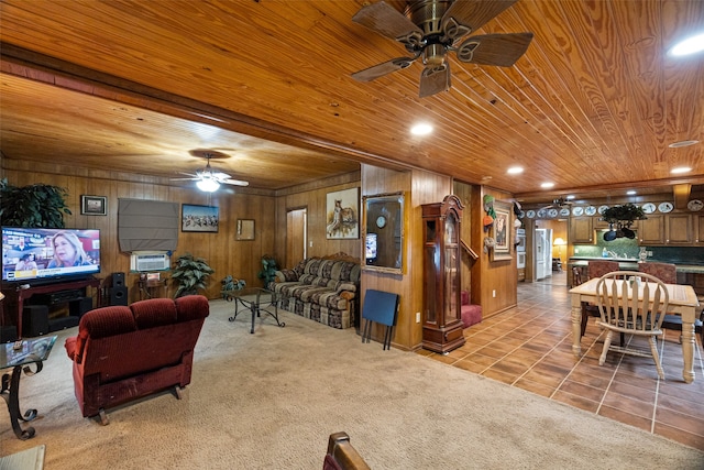 tiled living room with ceiling fan, wood walls, and wooden ceiling