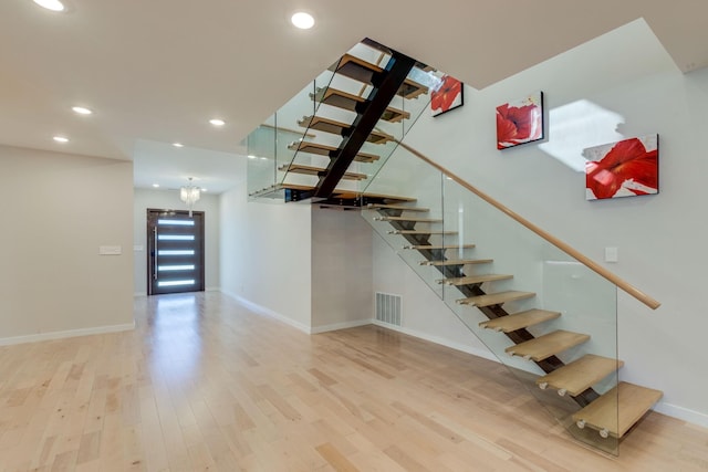 stairs with hardwood / wood-style floors