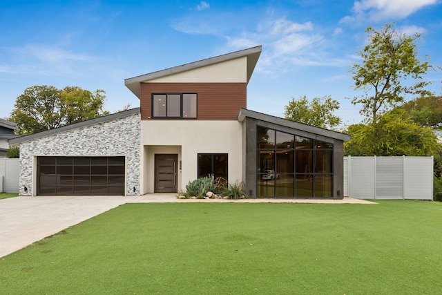 view of front of property with a garage and a front lawn