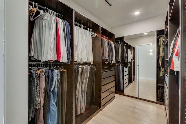 spacious closet with light hardwood / wood-style floors