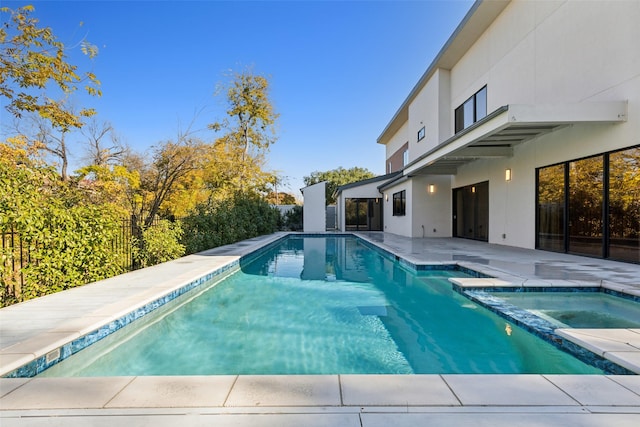 view of pool with a patio area and an in ground hot tub