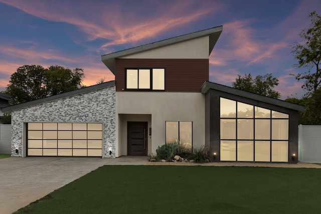 contemporary house with a lawn and a garage