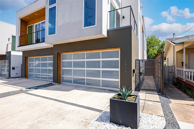 modern home featuring a garage and a balcony