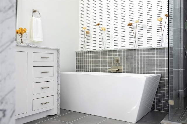 bathroom featuring tile walls, shower with separate bathtub, and tile patterned flooring