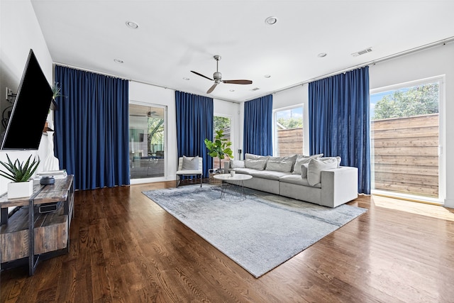 living room with wood-type flooring and ceiling fan