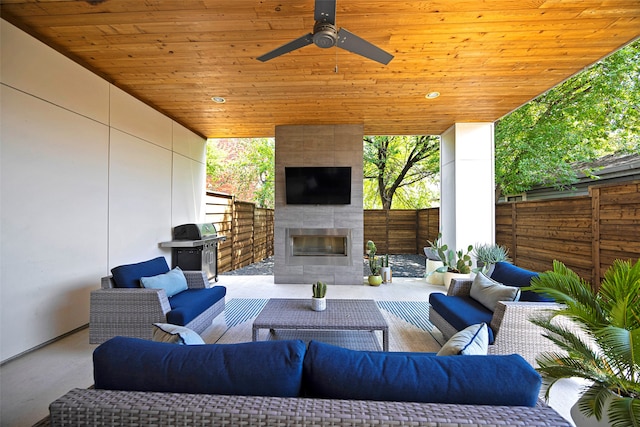 view of patio / terrace featuring ceiling fan, a grill, and an outdoor living space with a fireplace