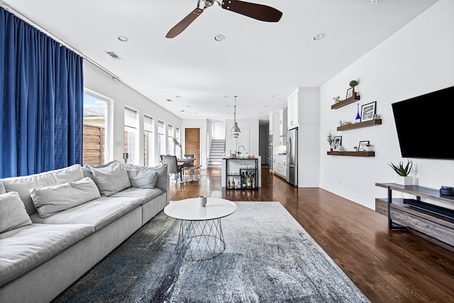 living room featuring dark hardwood / wood-style floors and ceiling fan