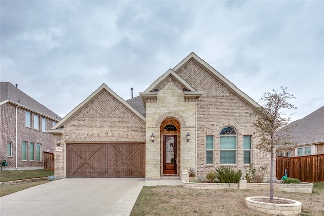 view of front of property with a garage and a front lawn