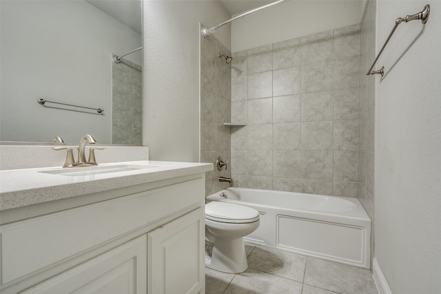 full bathroom featuring vanity, toilet, tile patterned flooring, and tiled shower / bath