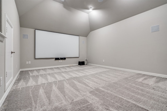 carpeted cinema featuring vaulted ceiling