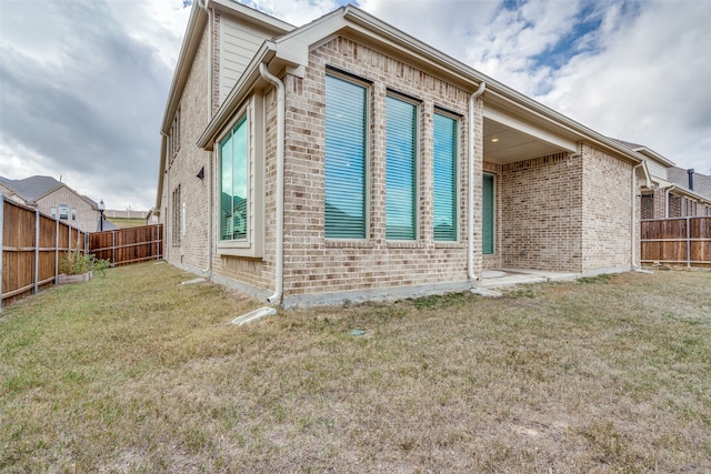 rear view of property featuring a lawn