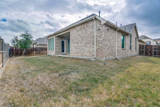 back of house with a yard