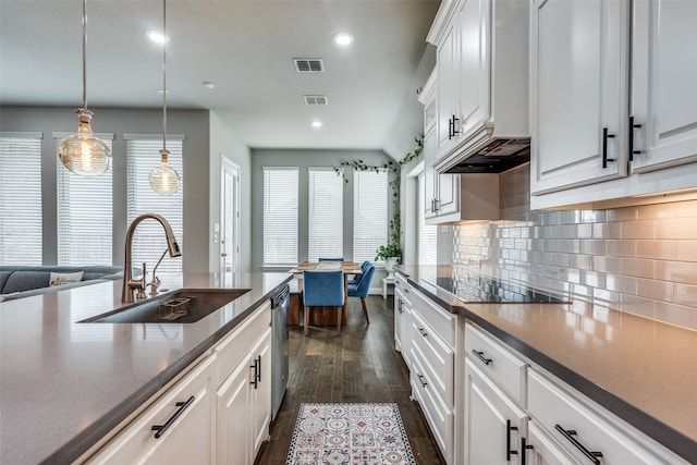 kitchen featuring dark hardwood / wood-style floors, black electric cooktop, hanging light fixtures, sink, and white cabinetry