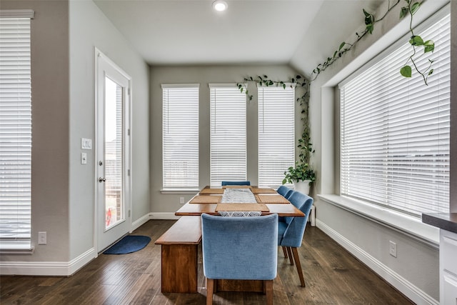 dining area with dark wood-type flooring and lofted ceiling