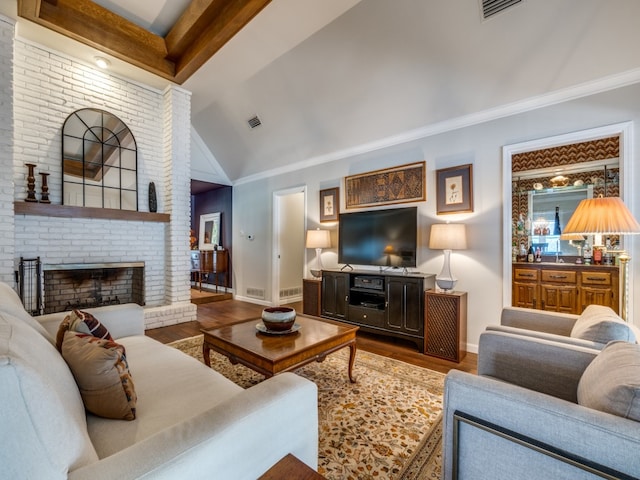 living room featuring high vaulted ceiling, hardwood / wood-style flooring, crown molding, and a fireplace