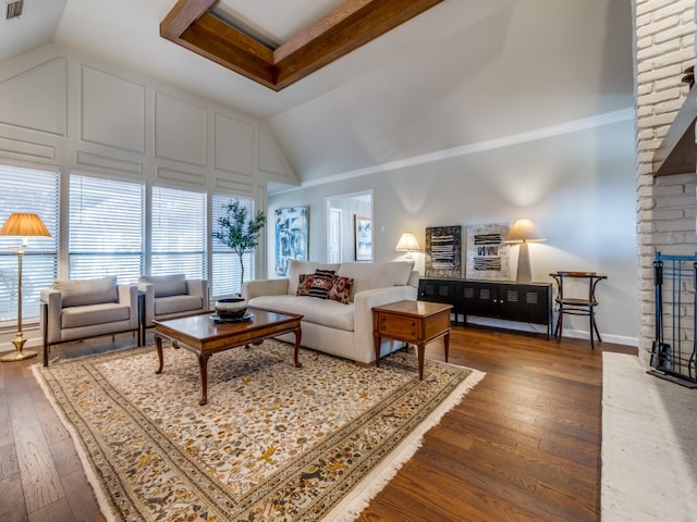 living room featuring vaulted ceiling, a brick fireplace, and dark hardwood / wood-style floors