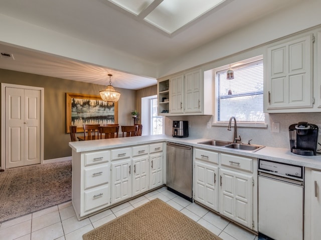 kitchen featuring sink, dishwasher, kitchen peninsula, a wealth of natural light, and pendant lighting