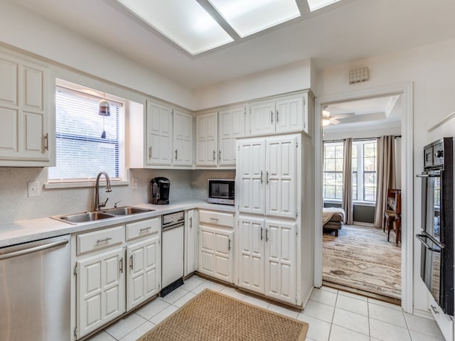 kitchen with sink, ceiling fan, appliances with stainless steel finishes, and a wealth of natural light