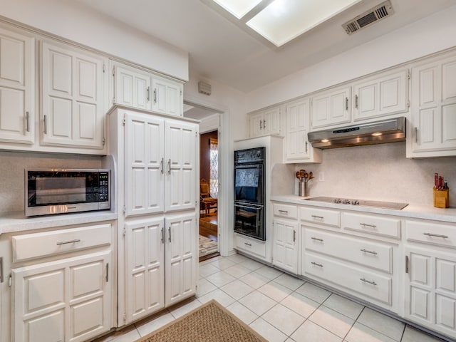 kitchen featuring white cabinetry, black appliances, and light tile patterned floors