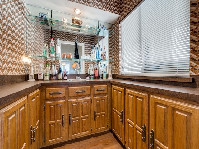 bar featuring sink and light wood-type flooring