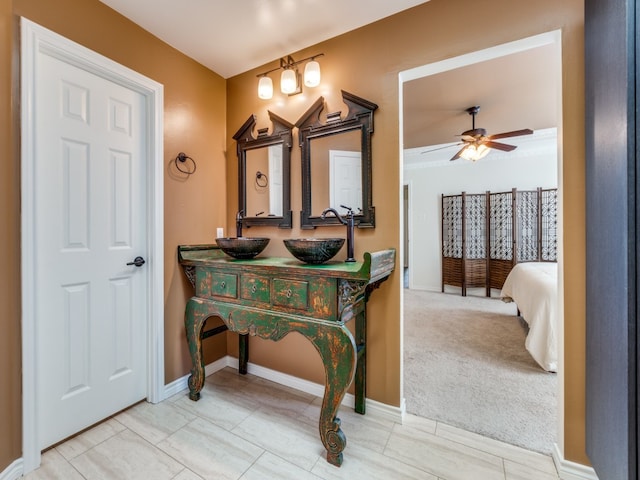 interior space with vanity and ceiling fan