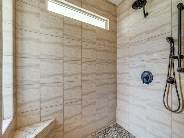 bathroom with a tile shower