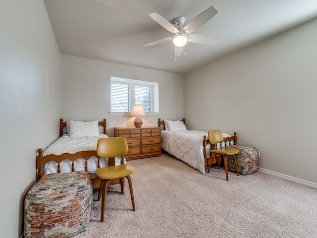 bedroom featuring ceiling fan and light carpet