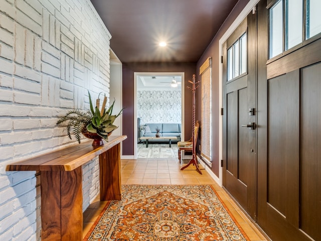 hallway featuring brick wall and light tile patterned floors