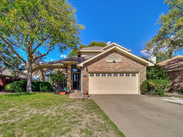 view of front of home with a garage and a front lawn