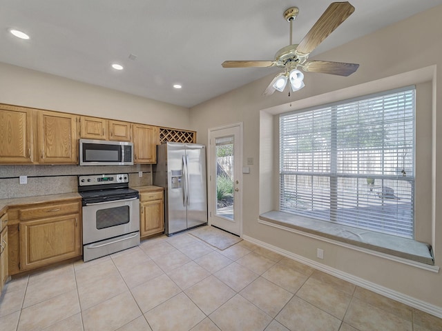 kitchen featuring tasteful backsplash, ceiling fan, appliances with stainless steel finishes, and light tile patterned floors