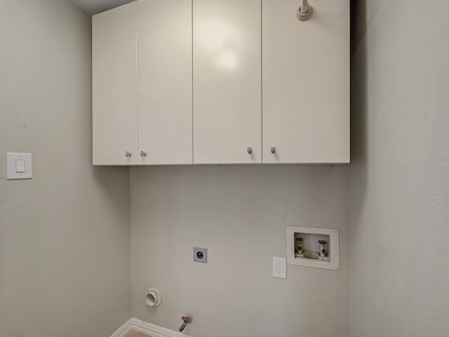 clothes washing area featuring hookup for a gas dryer, electric dryer hookup, washer hookup, and cabinets