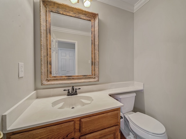 bathroom featuring ornamental molding, vanity, and toilet