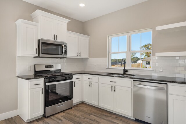 kitchen featuring sink, white cabinets, dark wood-type flooring, and stainless steel appliances