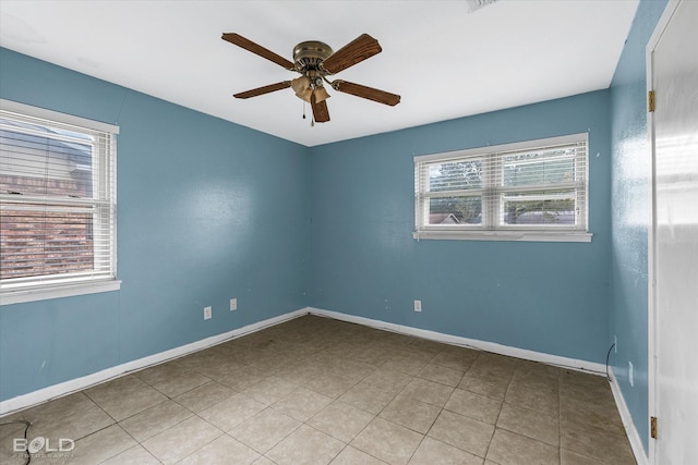 empty room with light tile patterned floors and ceiling fan