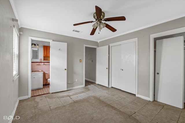 unfurnished bedroom with ornamental molding, connected bathroom, and ceiling fan