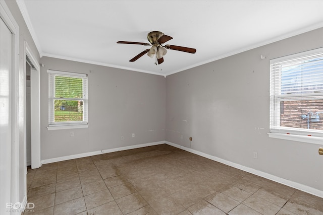 spare room with ornamental molding, a healthy amount of sunlight, light tile patterned floors, and ceiling fan