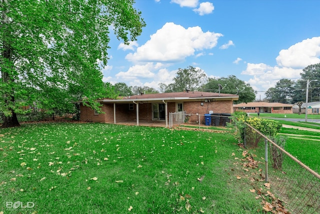 rear view of property with a patio area and a lawn