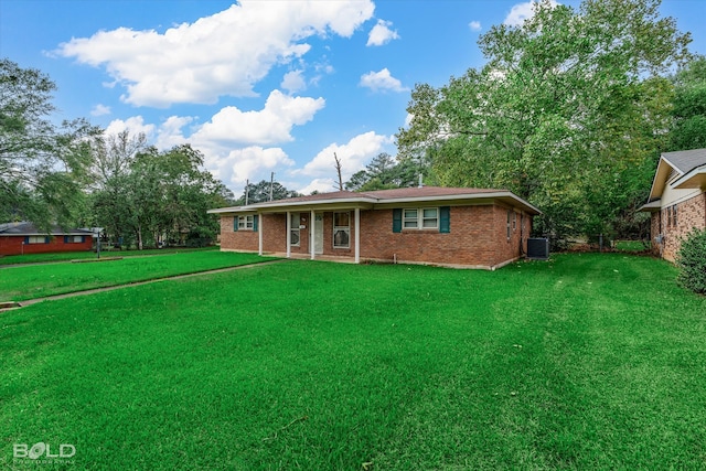 ranch-style house with a front yard and central AC