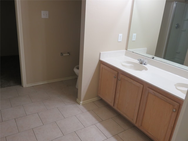 bathroom with vanity, walk in shower, toilet, and tile patterned floors