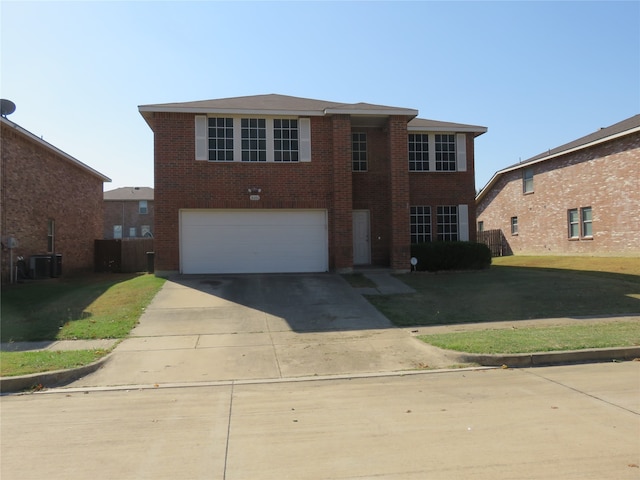 view of front of property featuring a garage and a front lawn