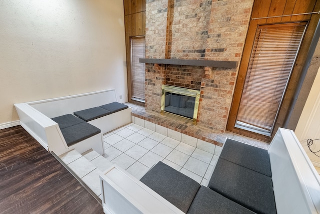 living room with a fireplace and light wood-type flooring