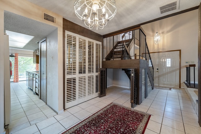 interior space with an inviting chandelier and a textured ceiling