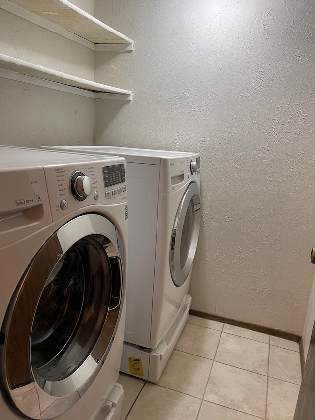 clothes washing area featuring separate washer and dryer and light tile patterned floors