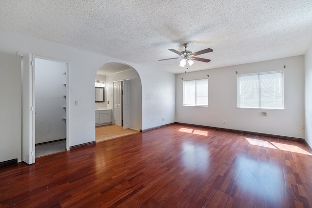 spare room featuring ceiling fan, wood-type flooring, and a textured ceiling